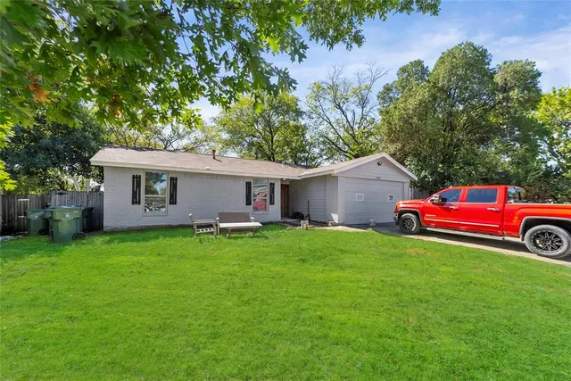 a view of a house with a backyard