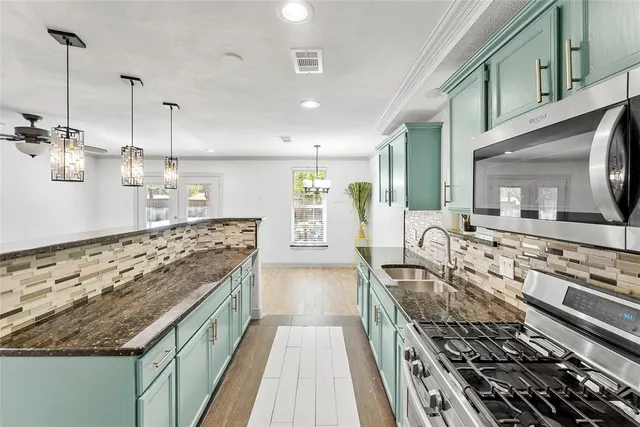 a kitchen with stove top oven and cabinets