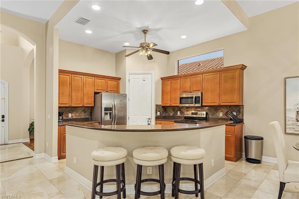 20002 Grande Lake Drive Estero, FL 33928 - Photo 11 of 38 a kitchen with stainless steel appliances a sink and cabinets