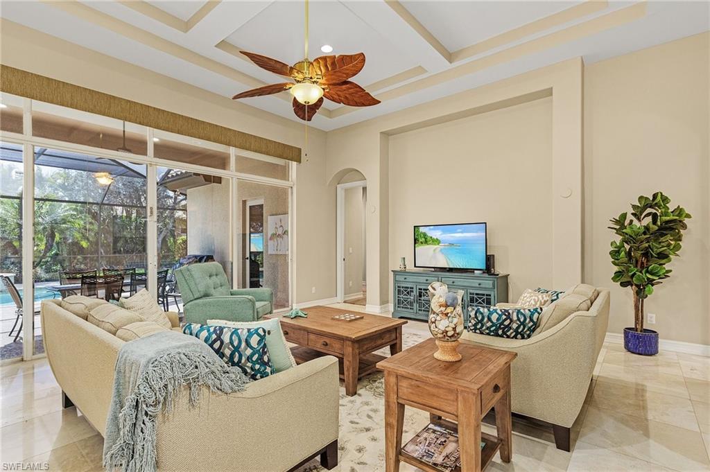 20002 Grande Lake Drive Estero, FL 33928 - Photo 14 of 38 a living room with furniture a chandelier and a flat screen tv