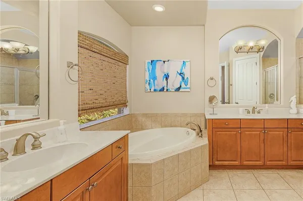 a spacious bathroom with a sink mirror and a bathtub
