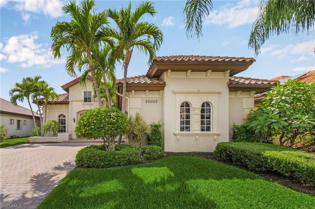 20002 Grande Lake Drive Estero, FL 33928 - Photo 2 of 38 a front view of a house with a yard