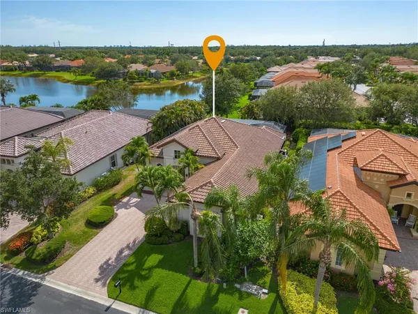 an aerial view of residential houses with outdoor space and river