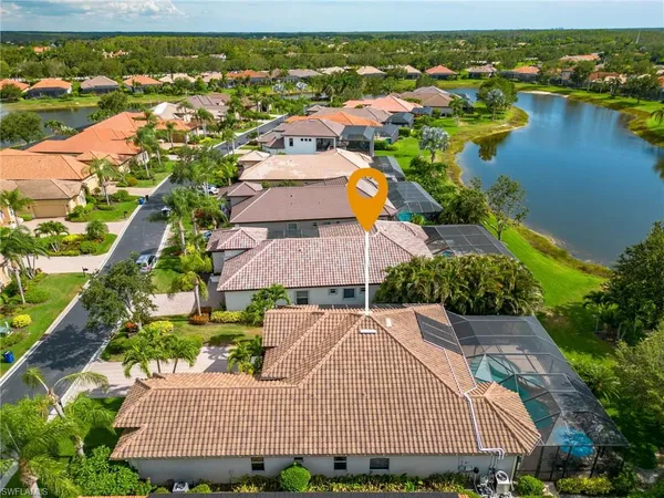 an aerial view of residential houses with outdoor space and river