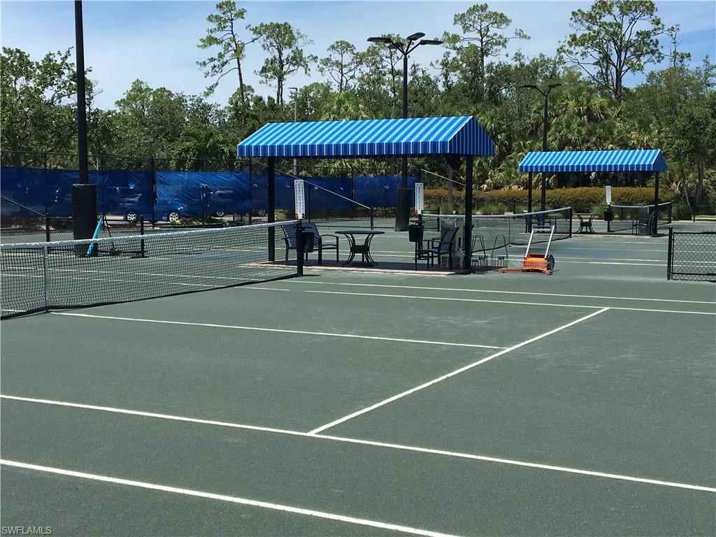 20002 Grande Lake Drive Estero, FL 33928 - Photo 35 of 38 a view of a tennis ground with large trees