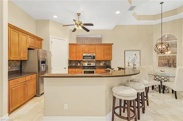 a kitchen with stainless steel appliances a sink and a refrigerator