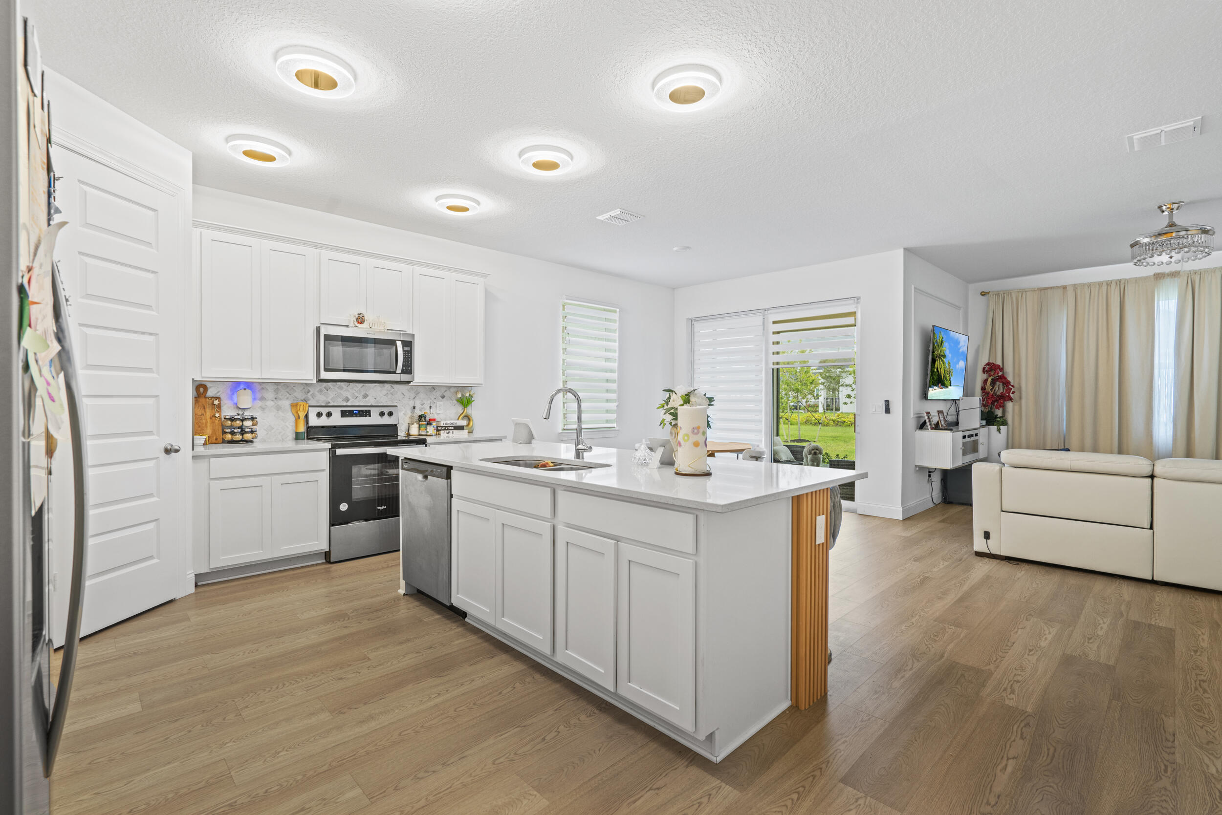 8906 Dahlia Circle Port St. Lucie, FL 34986 - Photo 12 of 47 a kitchen with stove cabinets and refrigerator