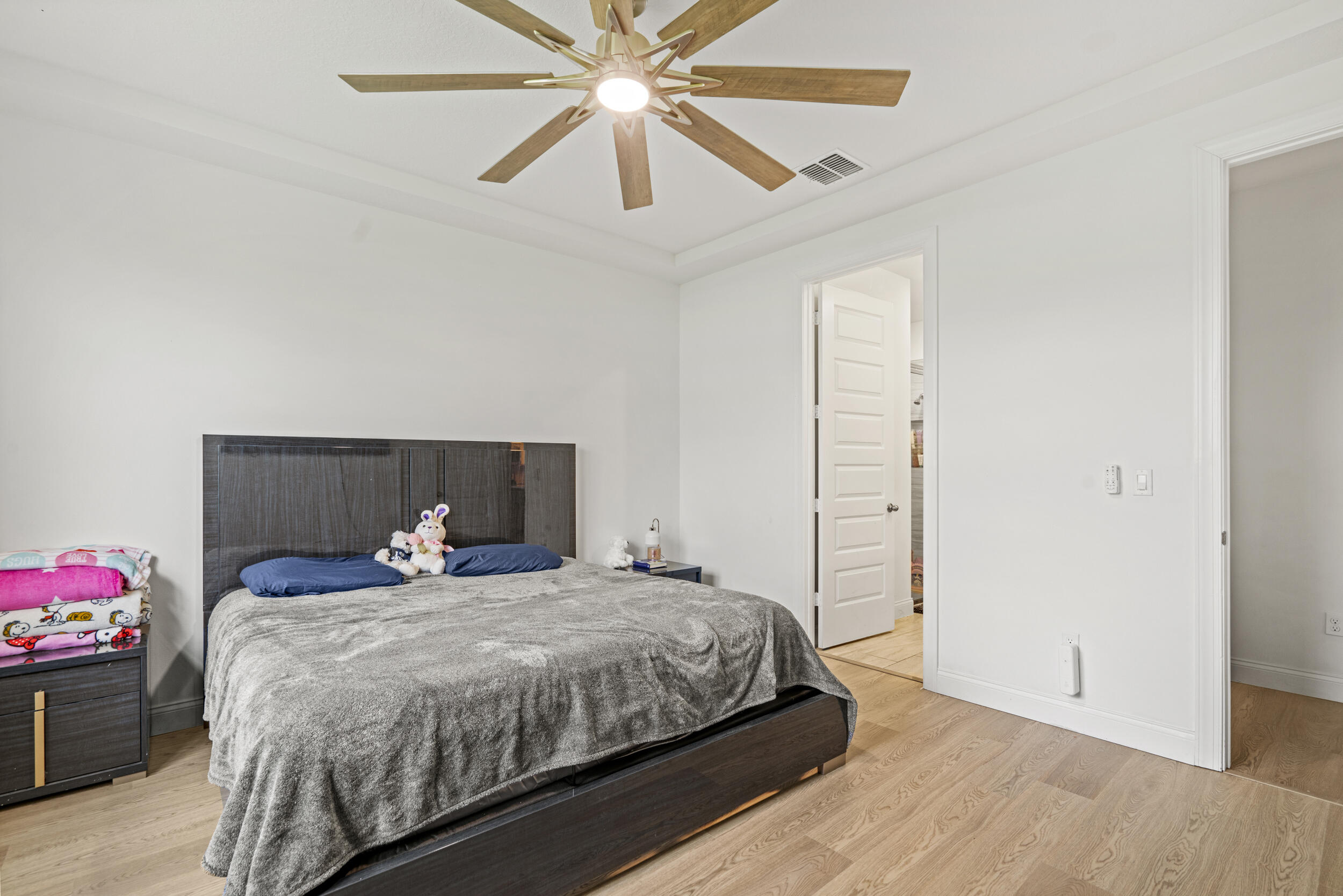 8906 Dahlia Circle Port St. Lucie, FL 34986 - Photo 14 of 47 a bedroom with a bed and a chandelier