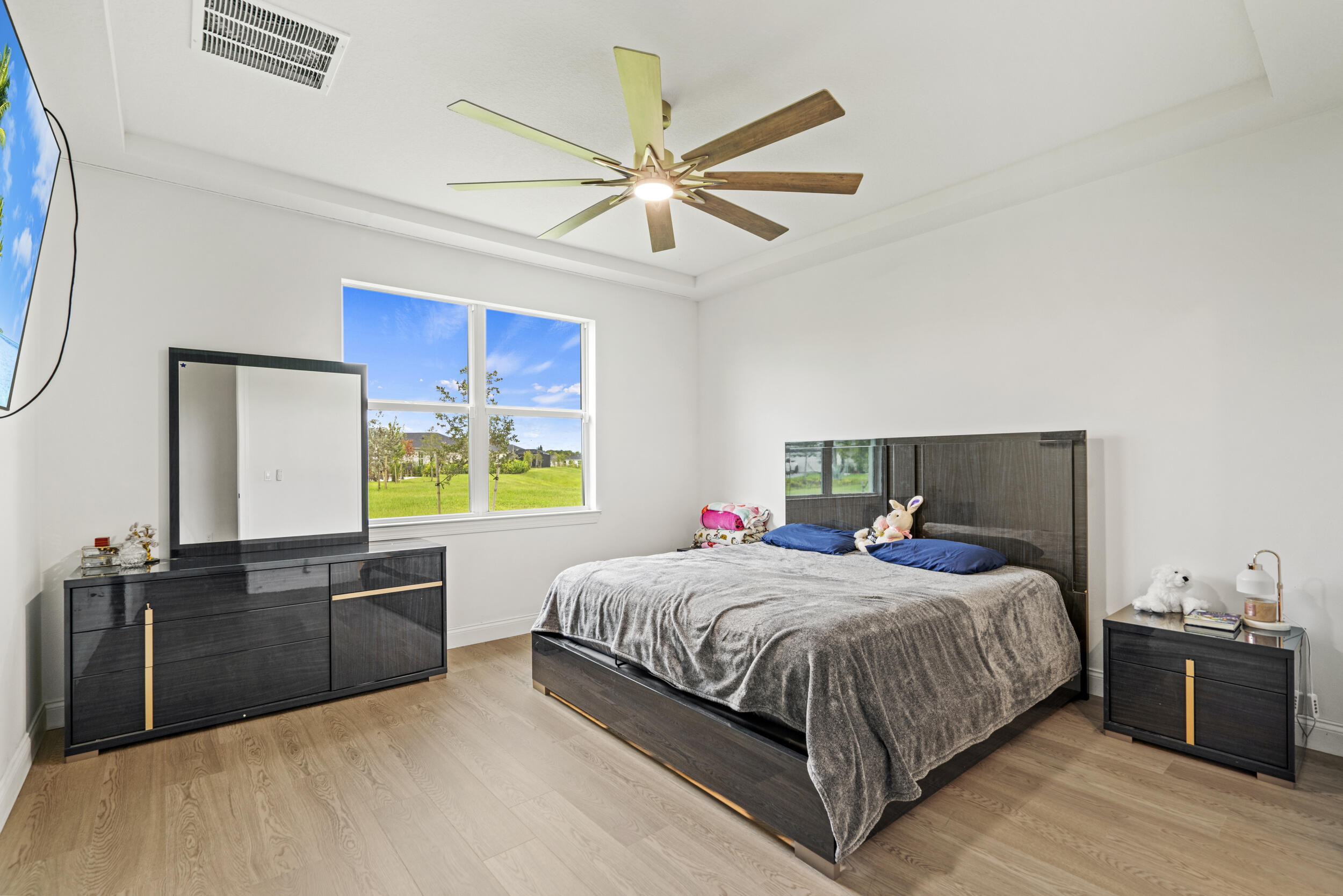 8906 Dahlia Circle Port St. Lucie, FL 34986 - Photo 15 of 47 a bedroom with a bed and window