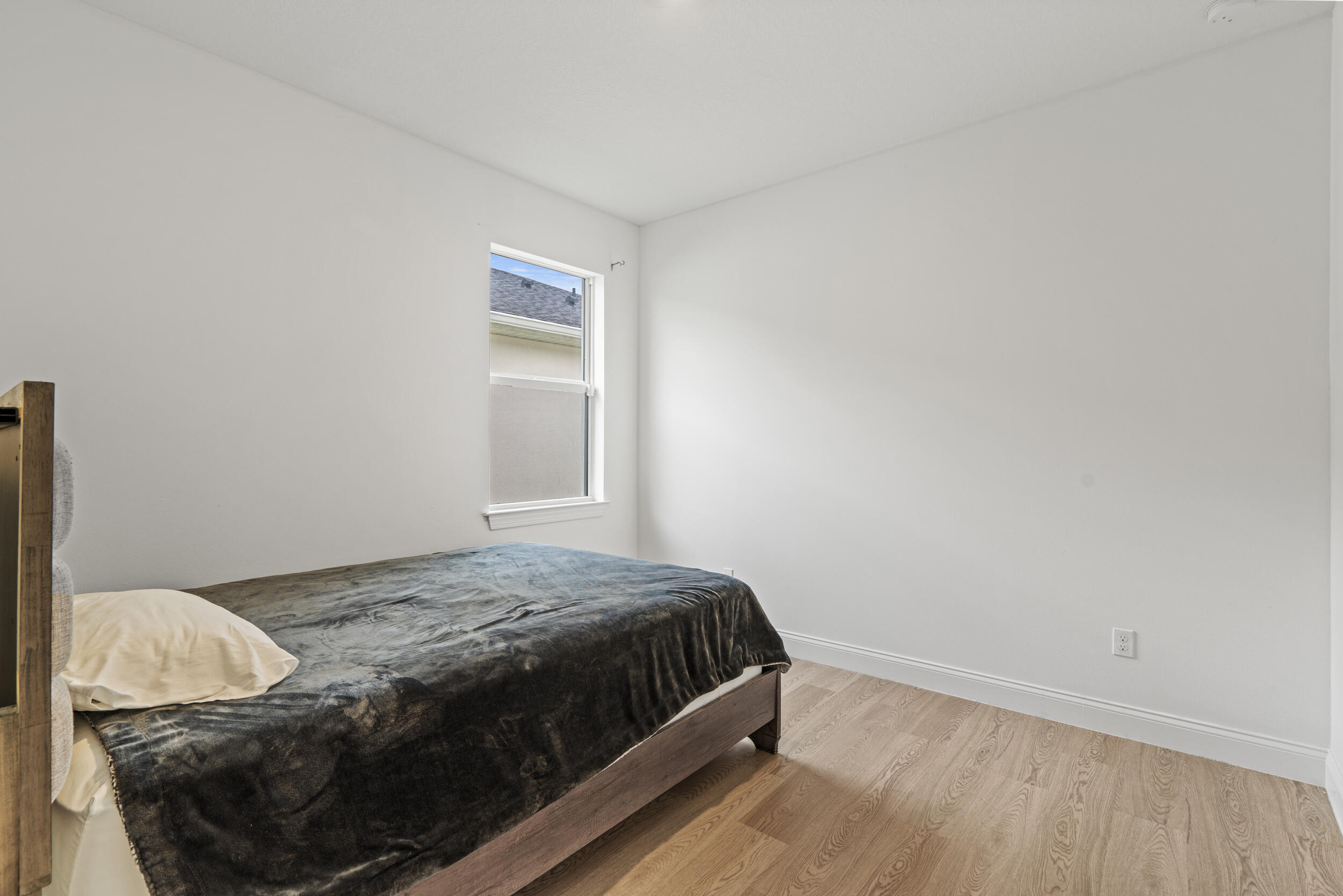 8906 Dahlia Circle Port St. Lucie, FL 34986 - Photo 17 of 47 a bedroom with a bed and a window