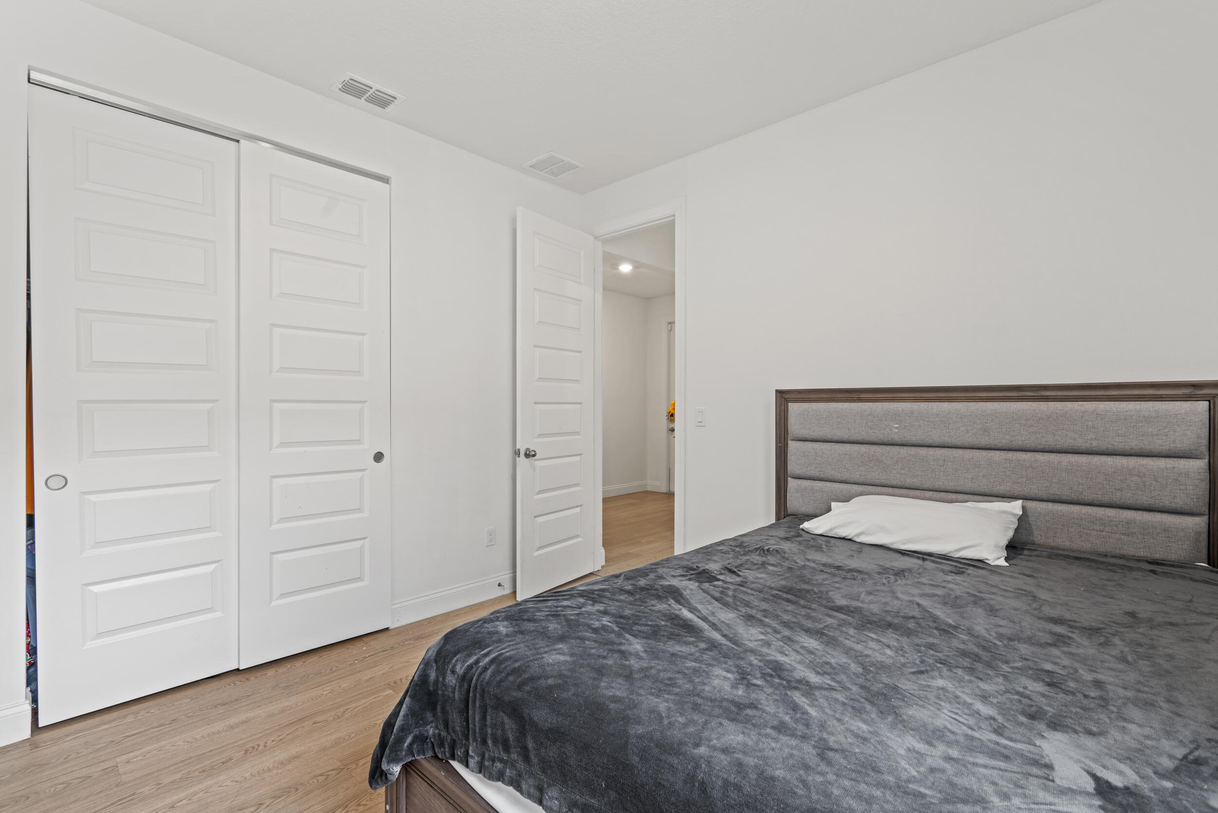 8906 Dahlia Circle Port St. Lucie, FL 34986 - Photo 18 of 47 a bedroom with a bed and cabinets