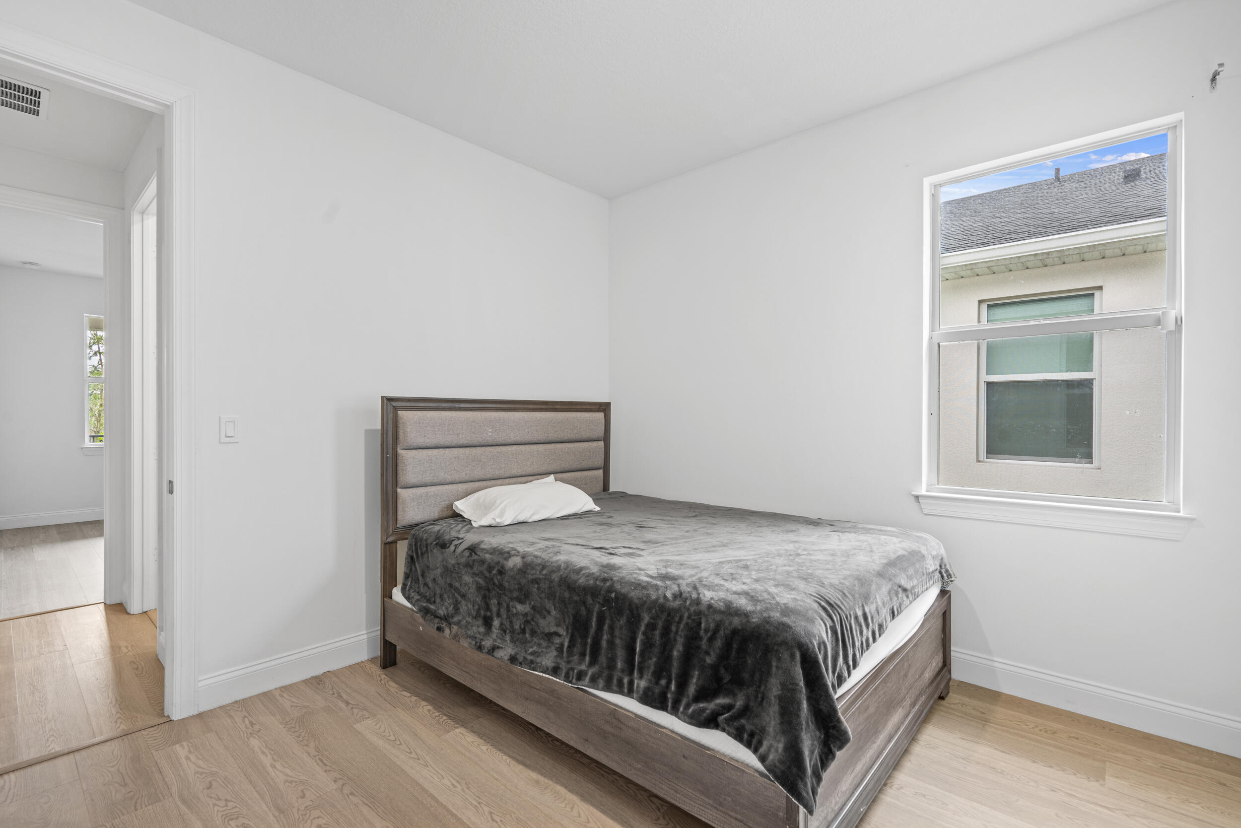 8906 Dahlia Circle Port St. Lucie, FL 34986 - Photo 19 of 47 a bedroom with a bed and window