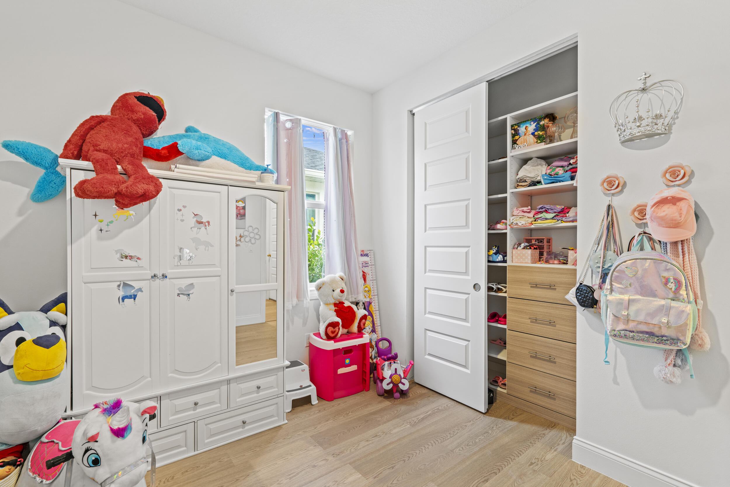 8906 Dahlia Circle Port St. Lucie, FL 34986 - Photo 21 of 47 a bedroom with a bed and cabinets