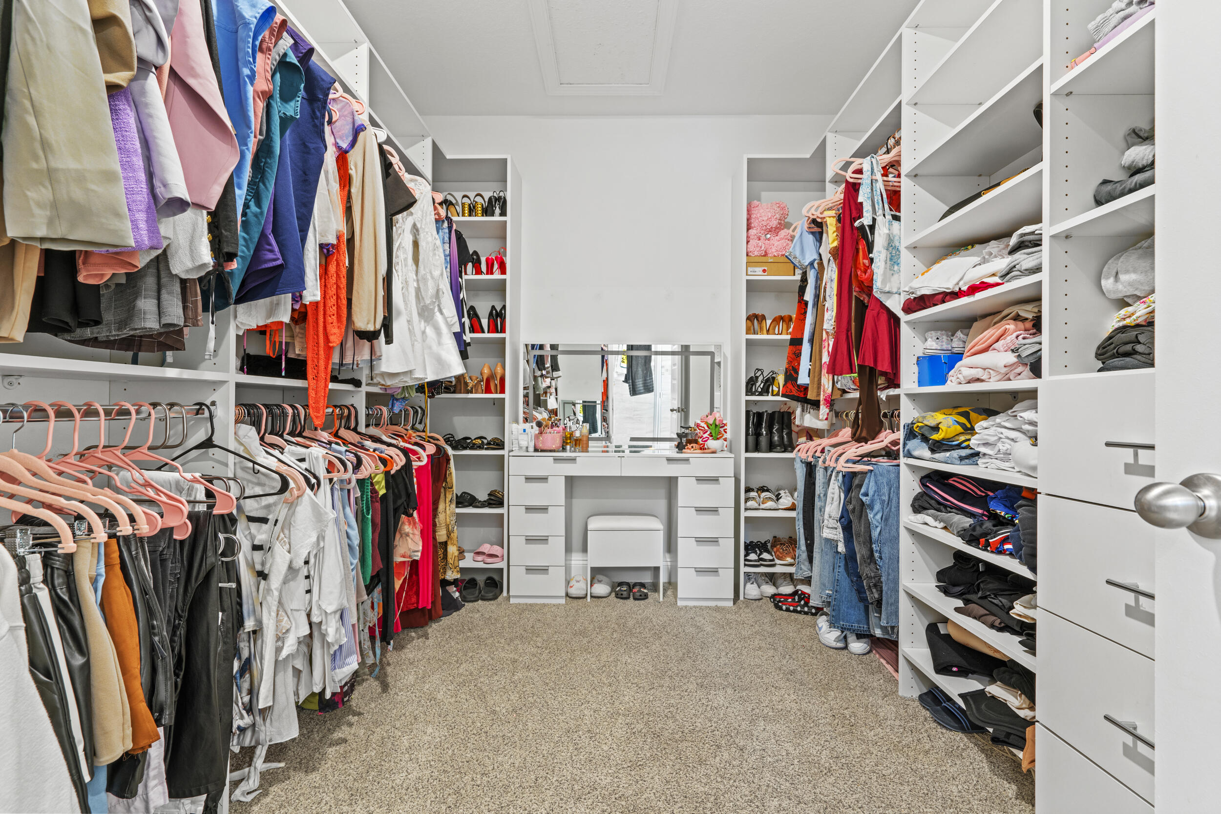 8906 Dahlia Circle Port St. Lucie, FL 34986 - Photo 26 of 47 a view of walk in closet with clothes and shoes