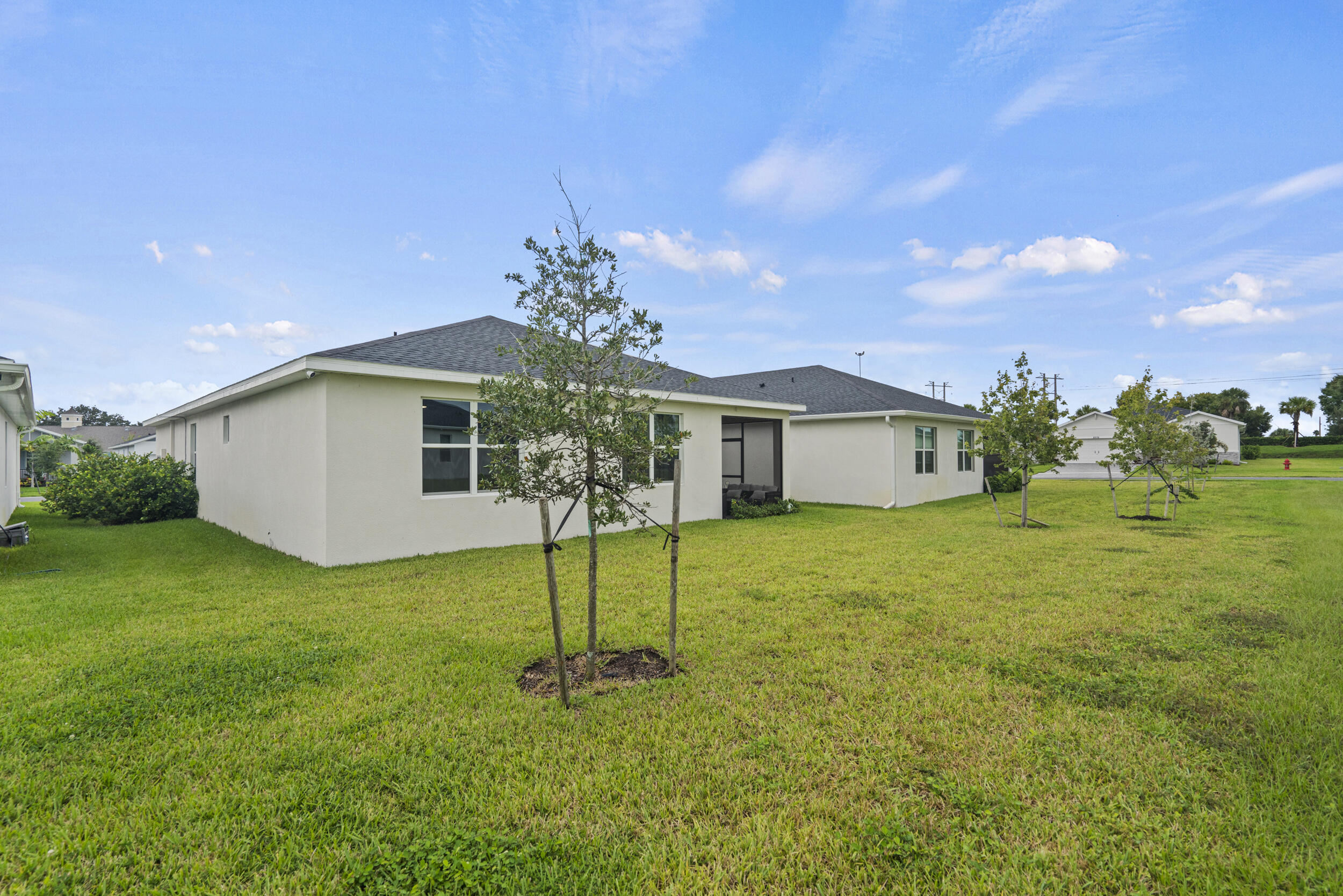 8906 Dahlia Circle Port St. Lucie, FL 34986 - Photo 35 of 47 a front view of a house with a garden