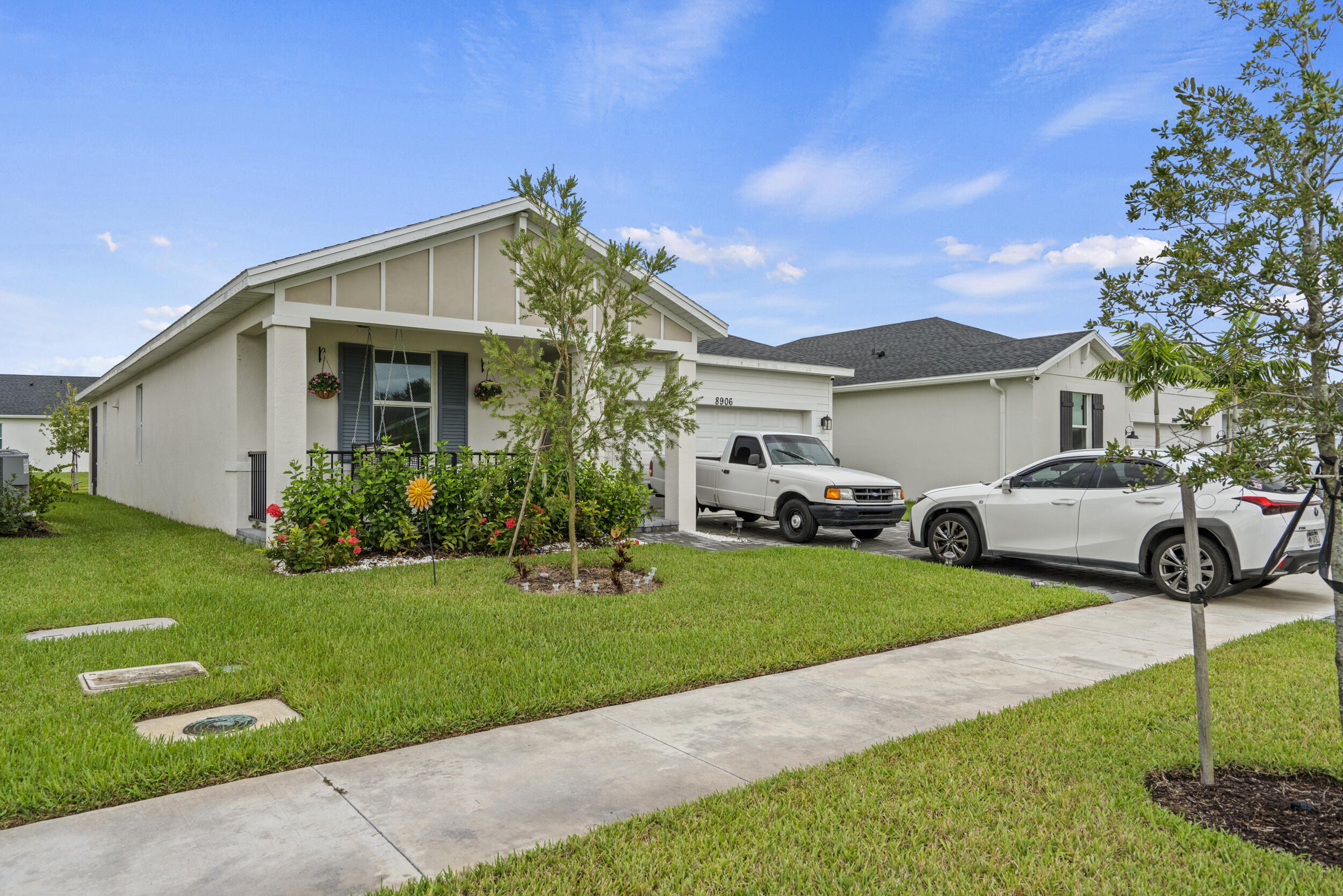 8906 Dahlia Circle Port St. Lucie, FL 34986 - Photo 4 of 47 a front view of a house with garden