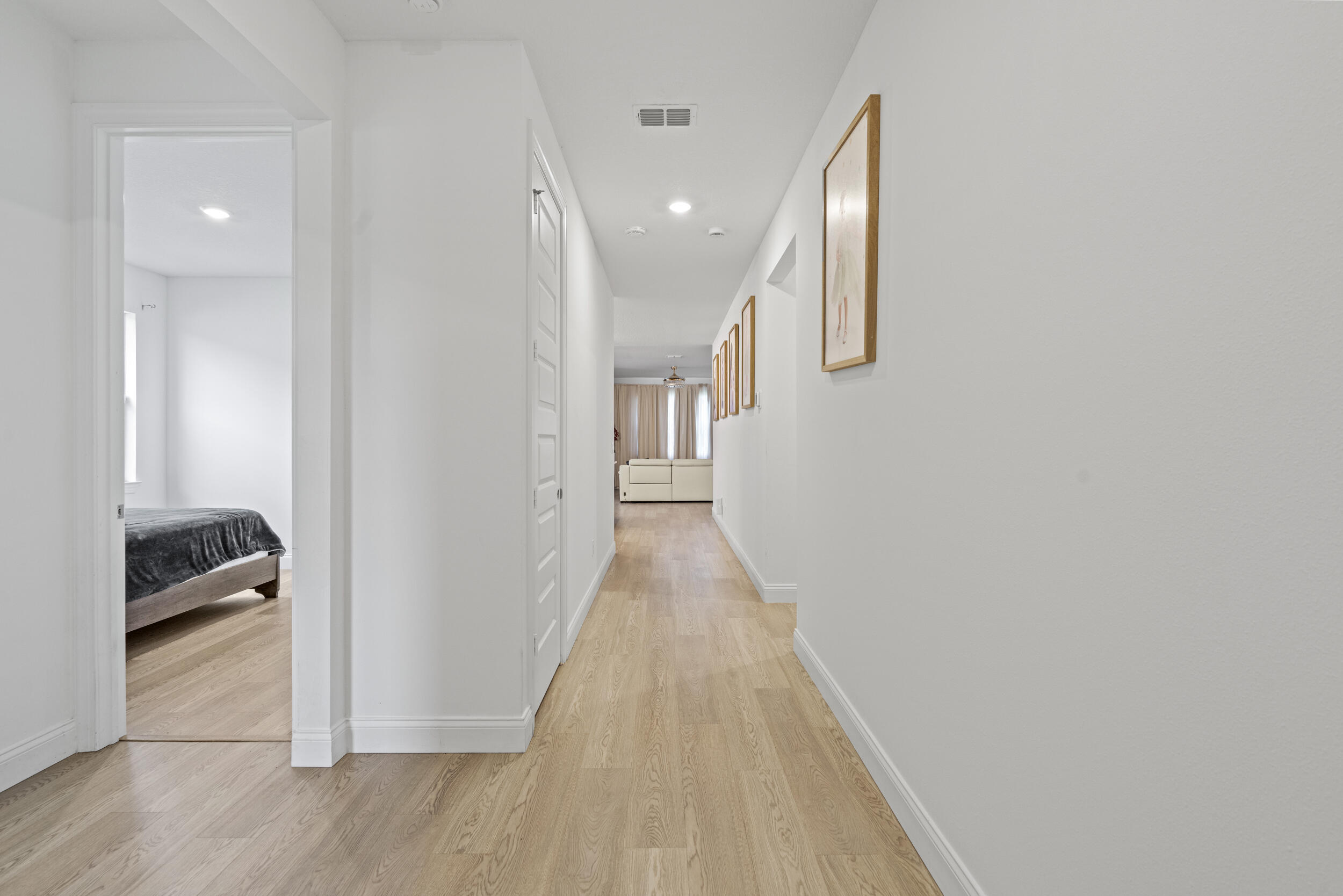 8906 Dahlia Circle Port St. Lucie, FL 34986 - Photo 7 of 47 a view of a hallway with wooden floor and stairs