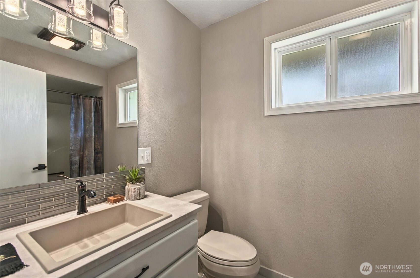 293 Highway 409 Cathlamet, WA 98612 - Photo 14 of 39 a bathroom with a sink a toilet and mirror