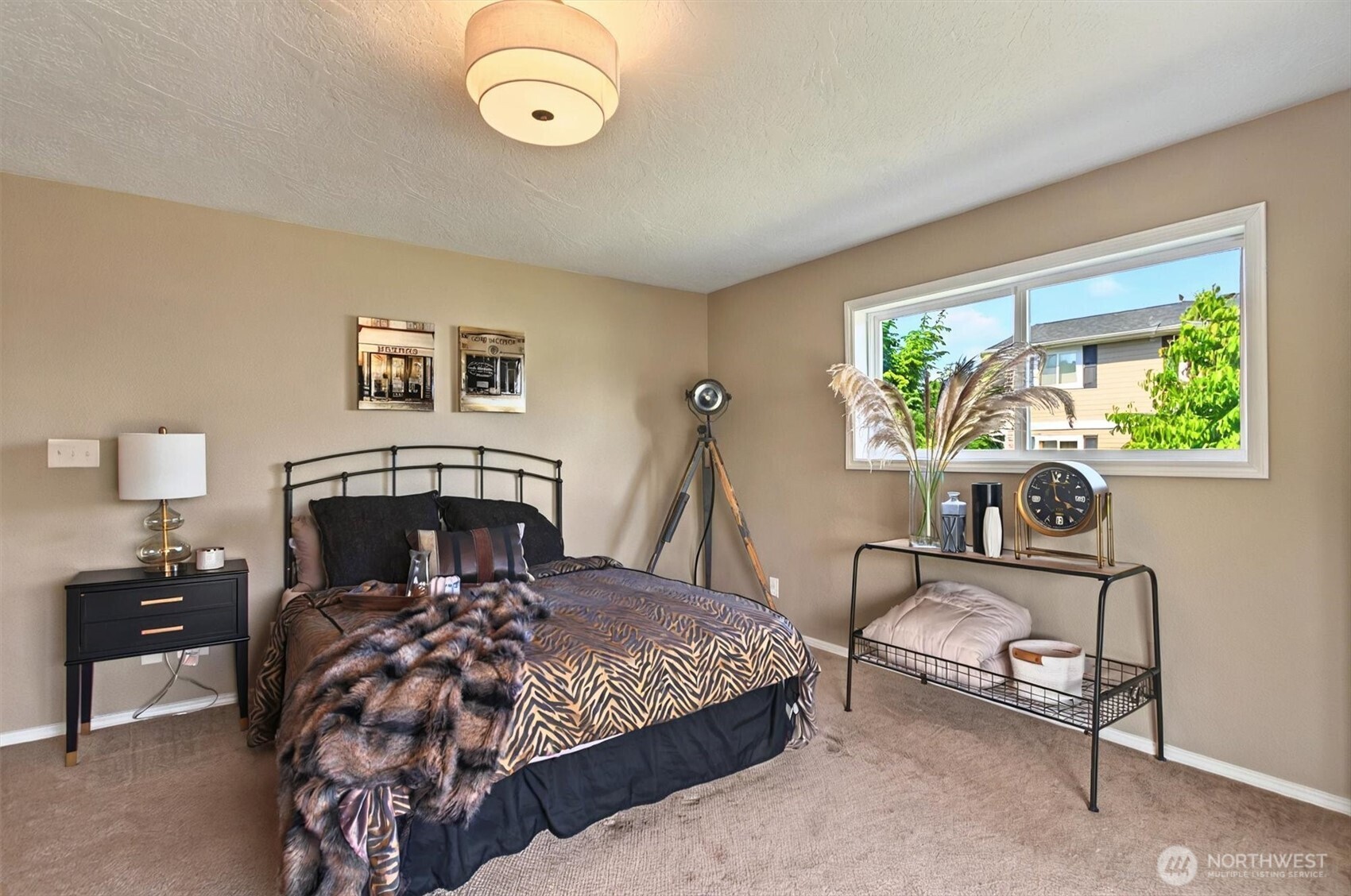293 Highway 409 Cathlamet, WA 98612 - Photo 21 of 39 a bedroom with a bed a chandelier and a window