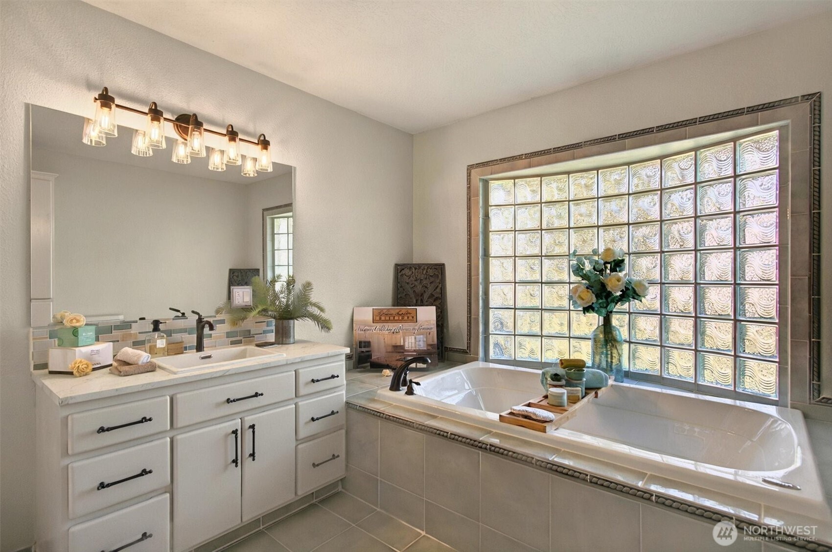 293 Highway 409 Cathlamet, WA 98612 - Photo 24 of 39 a bathroom with a double vanity sink bathtub and next to a window