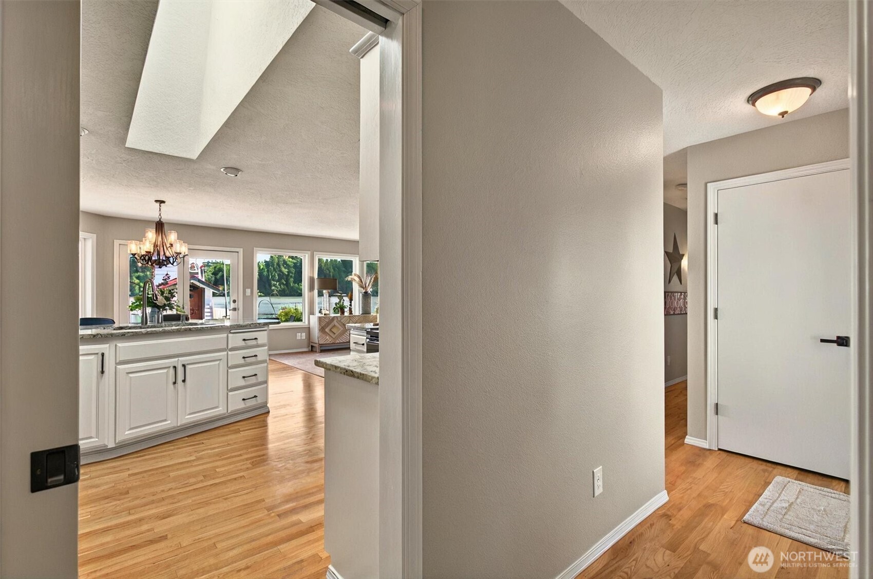 293 Highway 409 Cathlamet, WA 98612 - Photo 27 of 39 a kitchen with white cabinets and wooden floor