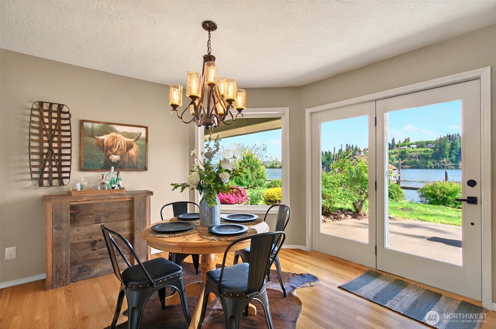 293 Highway 409 Cathlamet, WA 98612 - Photo 4 of 39 a view of a dining room with furniture a chandelier and wooden floor