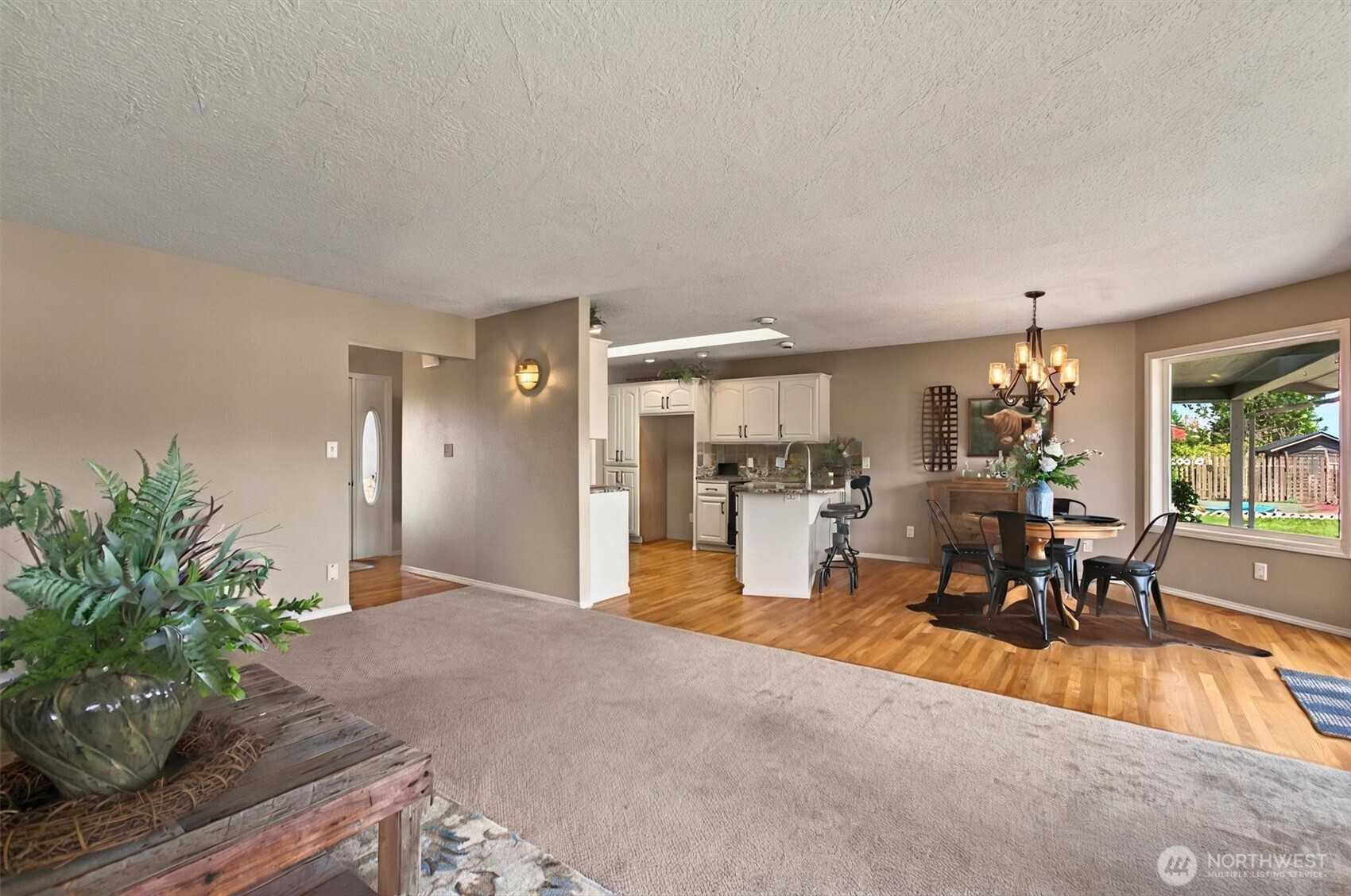 293 Highway 409 Cathlamet, WA 98612 - Photo 7 of 39 a living room with furniture a dining table and chairs with potted plants