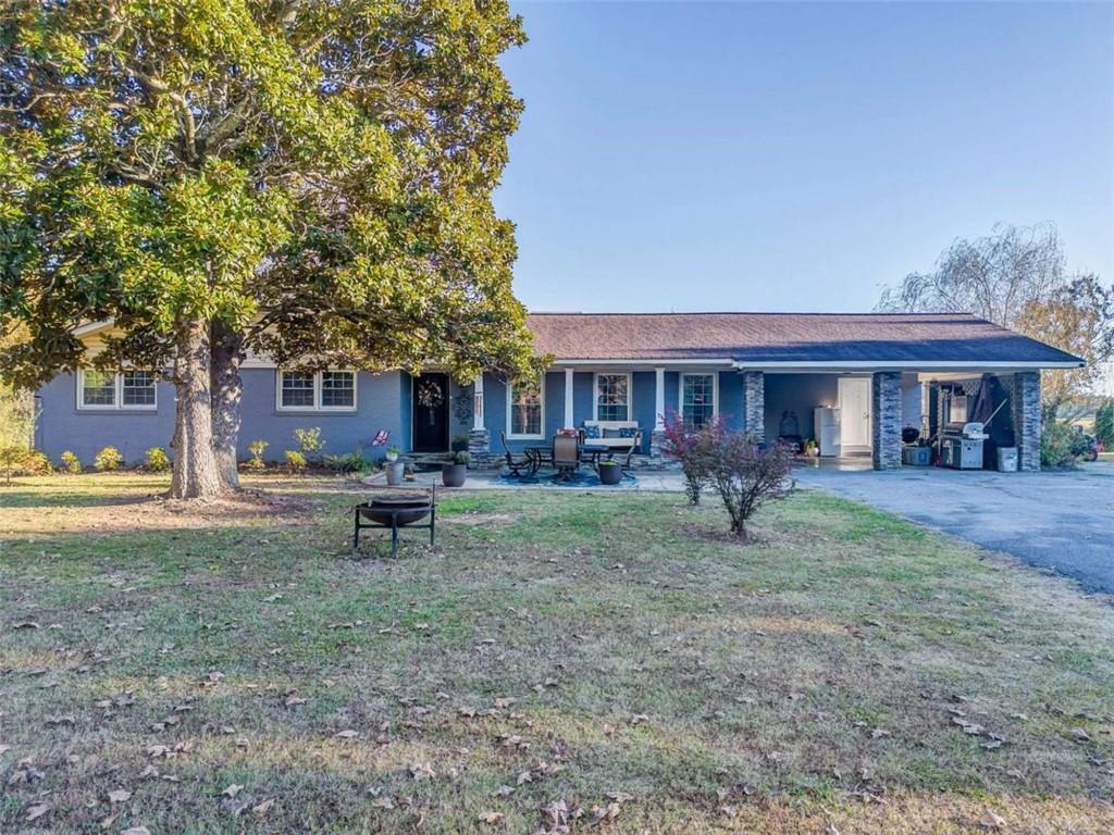 a view of a house with a yard porch and sitting area