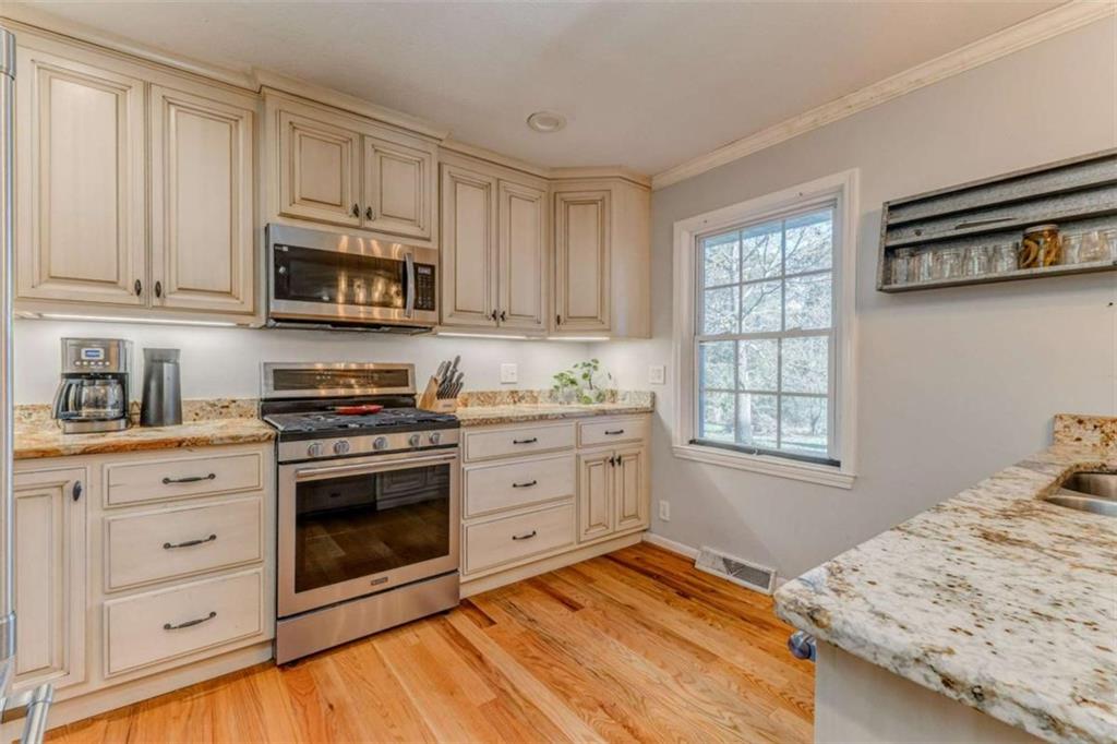 1522 Collard Valley Road Cedartown, GA 30125 - Photo 16 of 56 a kitchen with stainless steel appliances granite countertop a stove a sink and a microwave