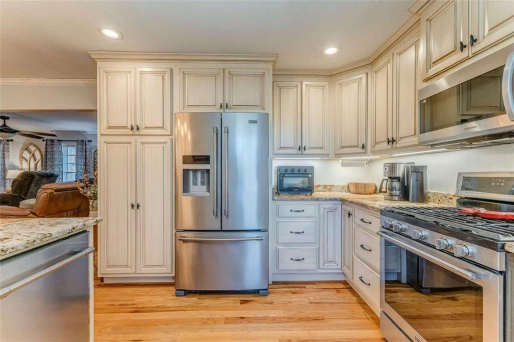 1522 Collard Valley Road Cedartown, GA 30125 - Photo 18 of 56 a kitchen with stainless steel appliances granite countertop a refrigerator stove and sink