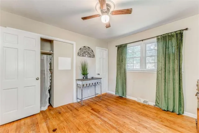 a bedroom with a bed dresser and a window