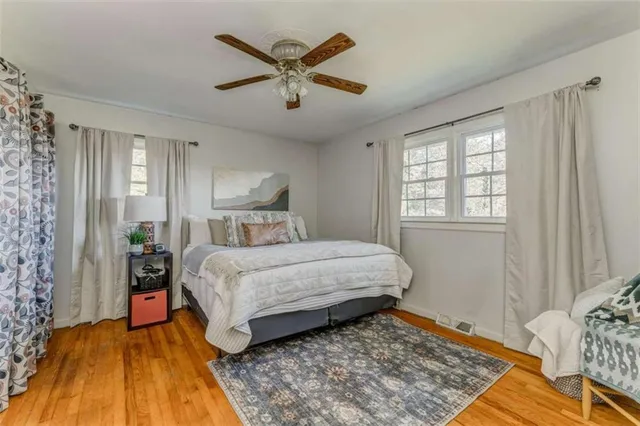 a bedroom with furniture and a flat screen tv