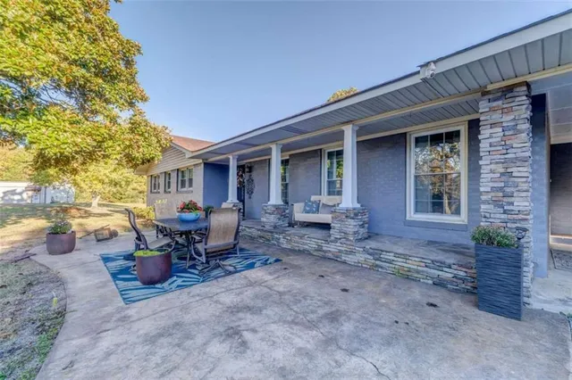a view of a patio with table and chairs and potted plants