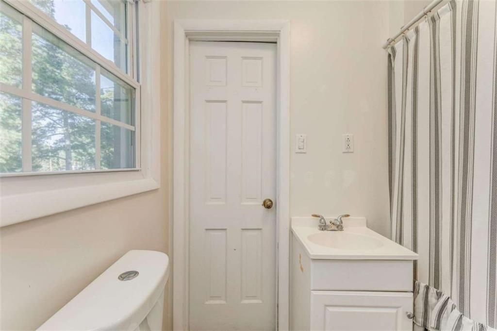 1522 Collard Valley Road Cedartown, GA 30125 - Photo 36 of 56 a bathroom with a sink a toilet and a mirror