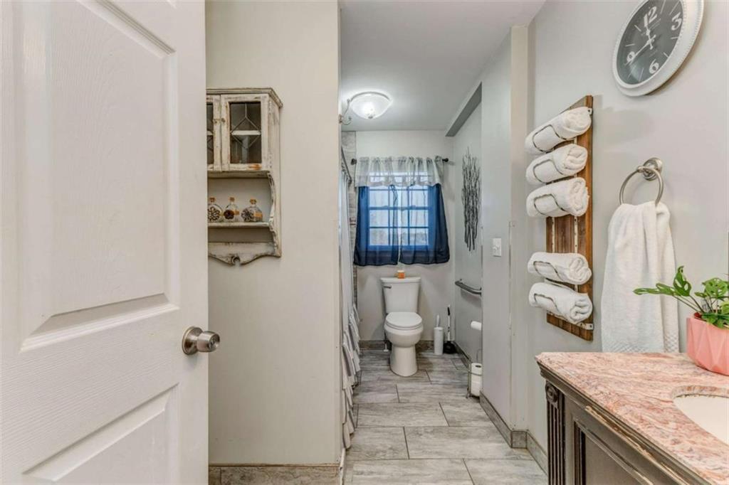 1522 Collard Valley Road Cedartown, GA 30125 - Photo 38 of 56 a bathroom with a granite countertop toilet sink and mirror