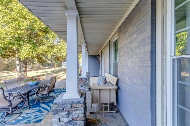 a view of a kitchen with furniture and wooden floor