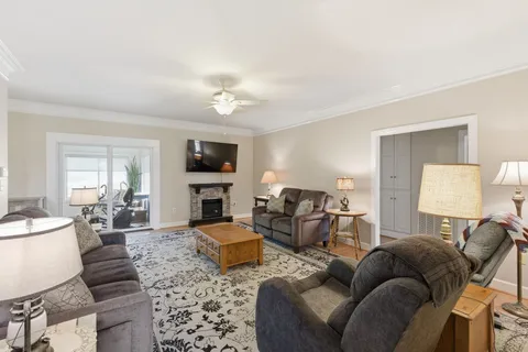 a living room with furniture fireplace and a flat screen tv