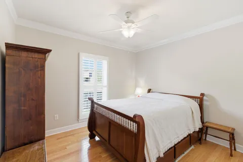 a bed sitting in a bedroom next to a wooden cabinet