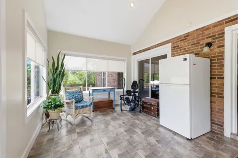 a view of living room filled with furniture and a refrigerator