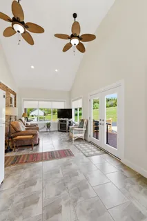 a living room with furniture and a chandelier