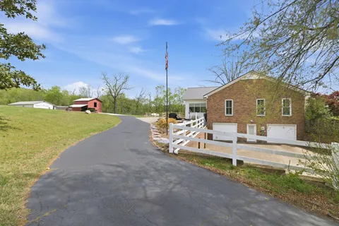 a front view of a house with a yard table and chairs