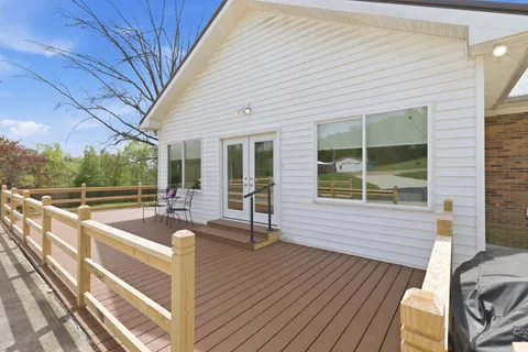 a view of a patio with table and chairs and wooden floor