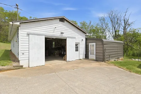 a view of a house with a yard and garage