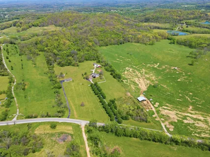 a aerial view of residential houses with outdoor space and trees