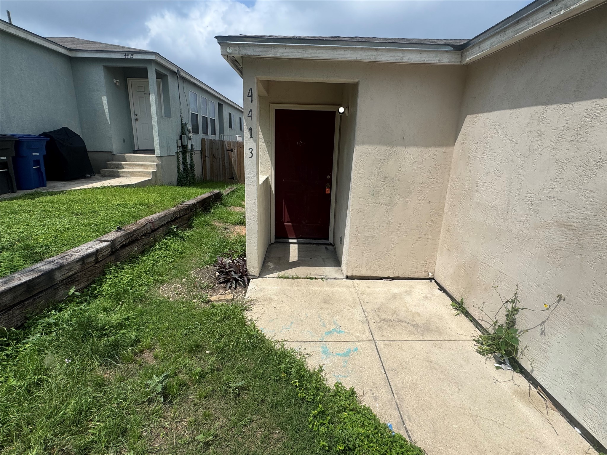 4411 Terra Summit Road San Antonio, TX 78233 - Photo 1 of 11 Entryway featuring a red door, stucco exterior, and a concrete path