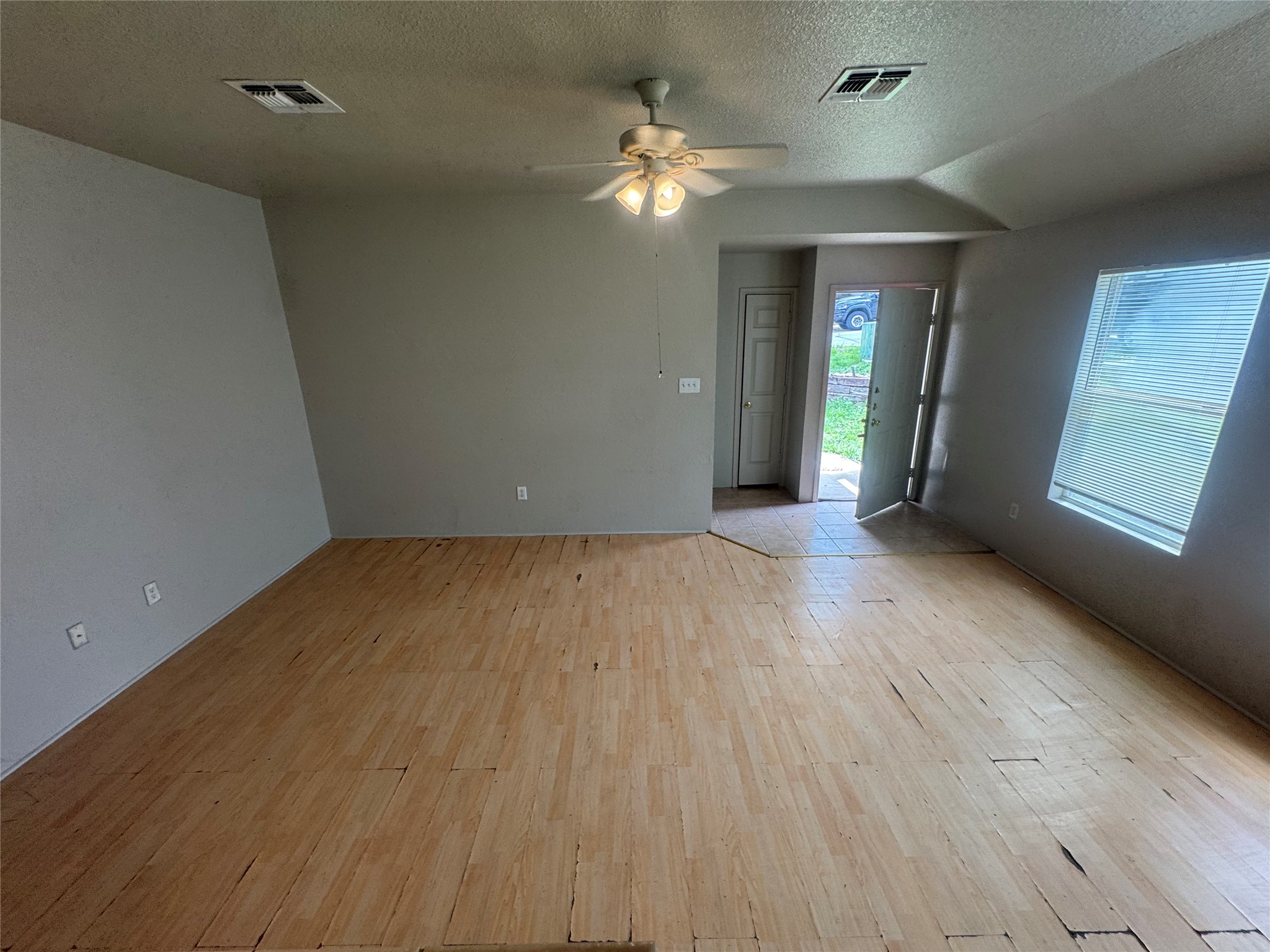 4411 Terra Summit Road San Antonio, TX 78233 - Photo 2 of 11 Spacious room featuring light-toned wood-finish flooring, a ceiling fan with integrated lighting, and multiple wall outlets