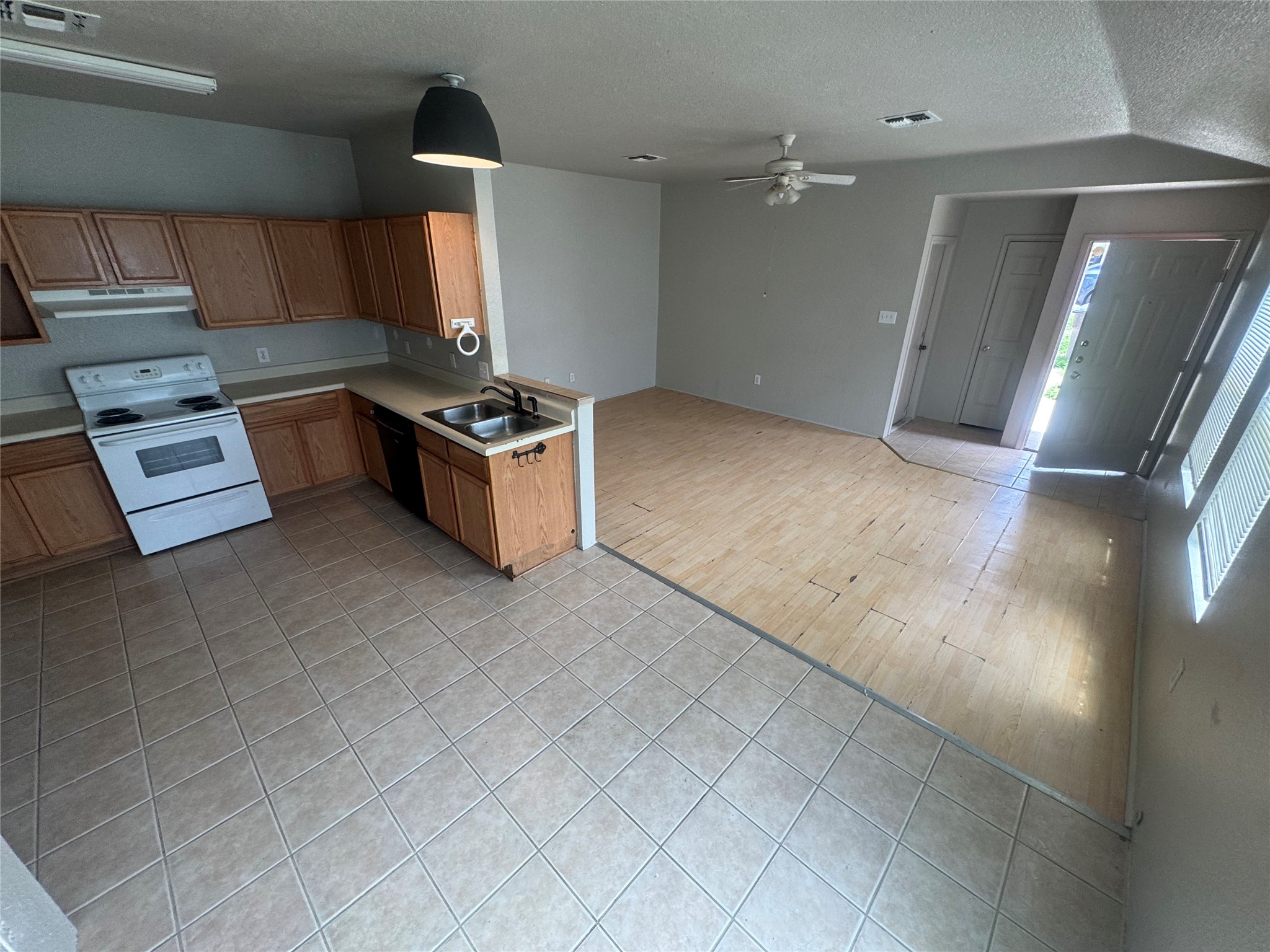 4411 Terra Summit Road San Antonio, TX 78233 - Photo 5 of 11 Kitchen featuring wood-finish cabinetry, tile flooring, and a white electric range