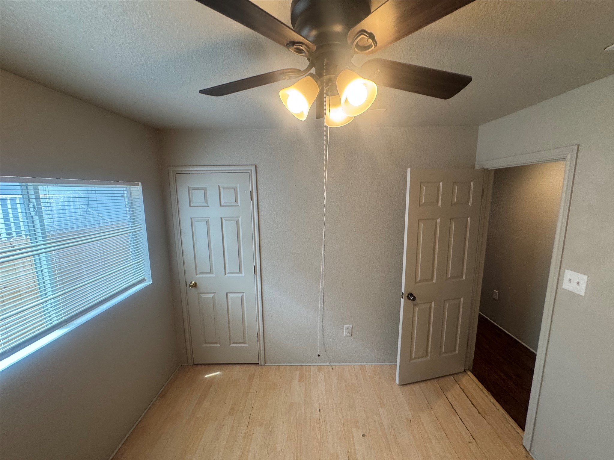 4411 Terra Summit Road San Antonio, TX 78233 - Photo 8 of 11 Room featuring wood-finish flooring, a window with horizontal blinds, and a ceiling fan with integrated lighting