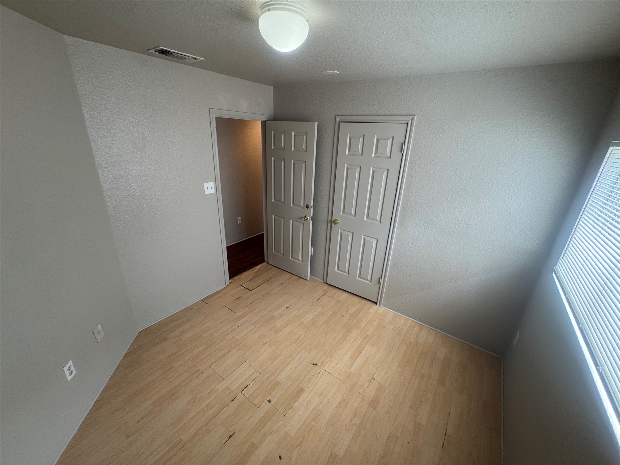 4411 Terra Summit Road San Antonio, TX 78233 - Photo 9 of 11 Room featuring light wood-finish flooring, neutral-toned walls, and a ceiling-mounted light fixture