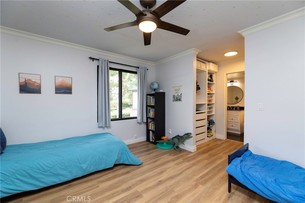 20702 El Toro Road, Unit 178 Lake Forest, CA 92630 - Photo 13 of 30 a bedroom with a bed and a chandelier